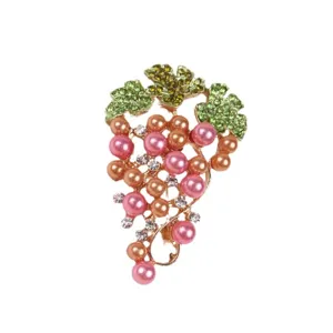 Elegant crystal grape brooch pin with pink pearls and rhinestones on white background