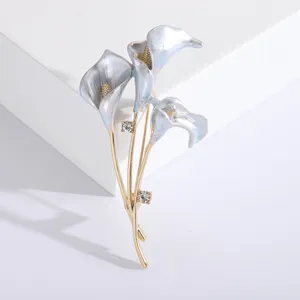 Elegant calla lily brooch with light blue enamel and sparkling rhinestones.