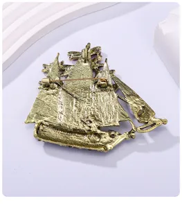 Detailed back view of a vintage antique gold sailing ship brooch featuring a secure safety pin