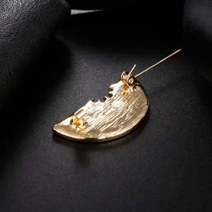 Detailed back view of a gold-plated watermelon brooch showing the pin mechanism.