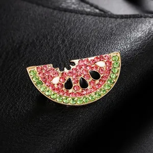 Close-up of watermelon brooch with red and green rhinestones and enamel seeds