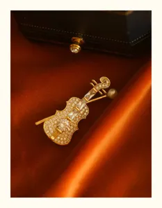 Detailed macro view of an elegant violin brooch with shimmering crystals and a pearl