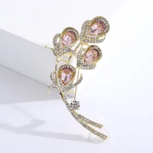 Close-up macro view of elegant calla lily brooch featuring pink crystals and rhinestones