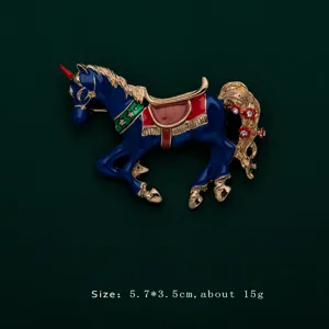 Detailed view of a blue enamel carousel horse brooch with gold accents and sparkling crystals.