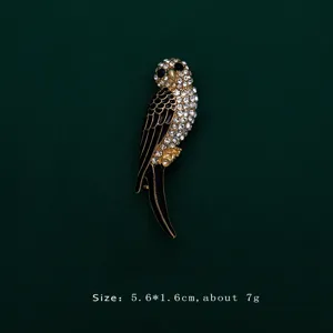 Detailed view of an elegant bird brooch with black enamel and sparkling rhinestones