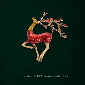 Close-up detail of a creative enamel deer brooch with red plum blossom antlers and gold finish