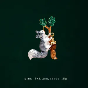 Macro view of an enamel squirrel brooch on a tree branch with acorn detail design