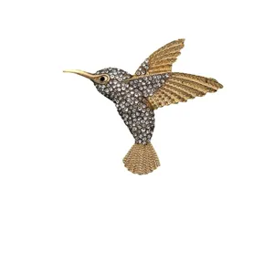 Elegant hummingbird brooch with sparkling crystal rhinestones in gold tone finish.