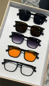 Detailed view of square frame sunglasses in five different lens colors displayed in a tray