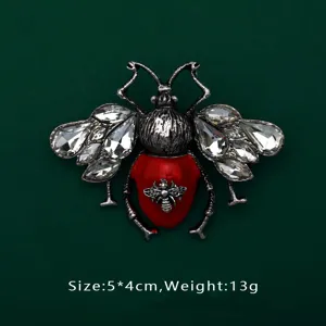Detail view of a luxury red beetle brooch with size 5x4cm and weight 13g specifications