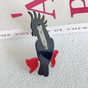 Detailed back view of the acrylic parrot brooch showing the secure metal pin closure.