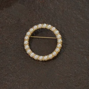 Elegant vintage gold circular brooch with white pearls in baroque palace style