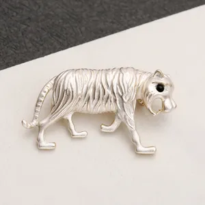 Macro detail of the realistic fur textures and black eye on this vintage silver tiger brooch.