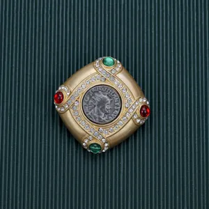 Close-up detail of a vintage Baroque square brooch with colorful gems and rhinestones