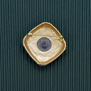 Macro view of vintage gold Baroque brooch back with secure safety pin mechanism.