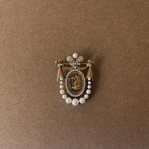 Exquisite baroque style vintage brooch featuring pearl tassels and a central cameo portrait