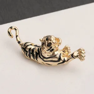 Close-up detail showing the intricate black enamel stripes on a vintage gold tiger brooch