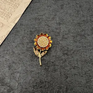 Detailed view of a vintage baroque sunflower brooch with yellow enamel and rhinestones