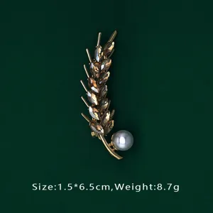 Exquisite macro detail of a luxury wheat ear brooch featuring brown crystals and white pearl