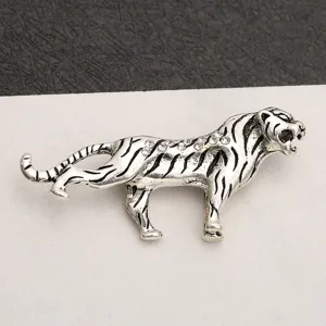 Close-up detail of vintage silver tiger brooch embellished with sparkling rhinestones