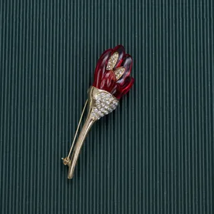 Close-up of vintage Baroque style red flower brooch with sparkling rhinestones