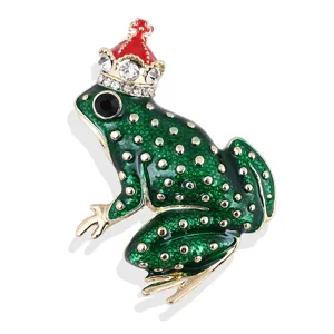 Detailed view of a whimsical green frog brooch featuring a sparkling jeweled crown.