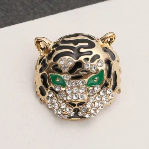 Detailed view of a vintage tiger head brooch with sparkling rhinestones and green eyes.