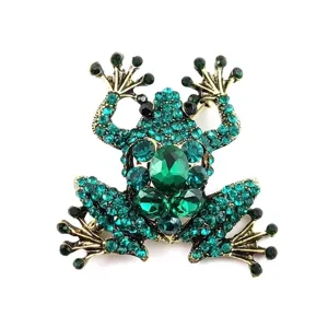 Macro view of a vivid green rhinestone-studded frog brooch pin with golden finish.