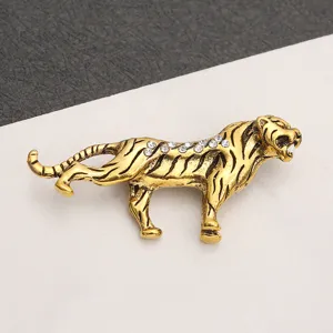 Detailed view of a vintage gold-toned tiger brooch pin accented with sparkly rhinestones