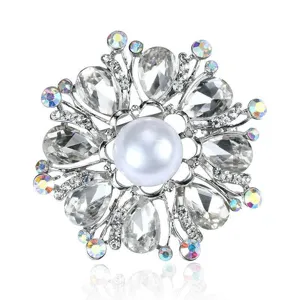 Luxurious snowflake brooch with a large pearl and sparkling clear crystals on silver base.