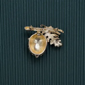 Detail view showing the secure back pin mechanism of the vintage acorn brooch.