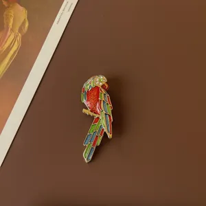Vibrant enamel parrot brooch with sparkling rhinestones in vintage baroque style