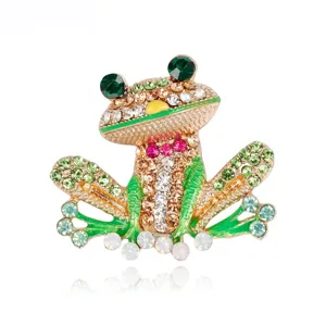 Detailed view of a funny frog brooch with colorful rhinestones and gold-tone finish