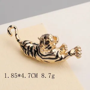 Detailed view of a vintage tiger brooch with gold finish and black enamel stripes