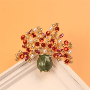 Macro view of an exquisite crystal floral vase brooch with red gems and white pearls