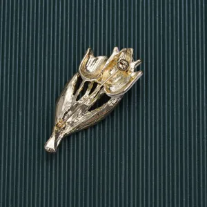 Detailed back view of vintage golden tulip bouquet brooch showing pin mechanism