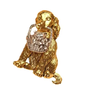 Detailed gold retriever dog brooch pin holding a silver basket with a kitten inside