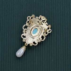 Detailed back view of vintage Baroque palace style brooch with gold finish and pearl drop