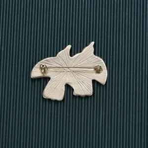 Back view of vintage gold Baroque brooch pin showing textured metal and safety clasp