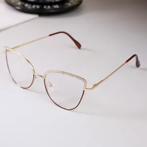 Detail of elegant cat-eye glasses frame with sparkling rhinestone accents on gold metal