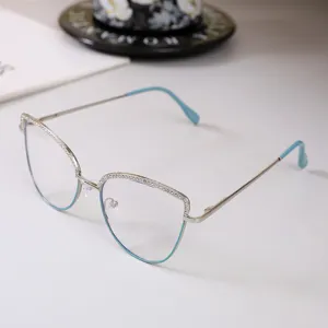Elegant silver cat-eye eyeglass frame with sparkling rhinestone trim and blue accents