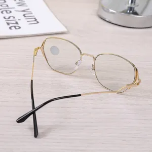 Detailed view of stylish hexagonal gold metal frame glasses with clear anti-blue light lenses