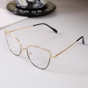 Close-up detail of stylish cat eye glasses with rhinestone accents and gold metal frame
