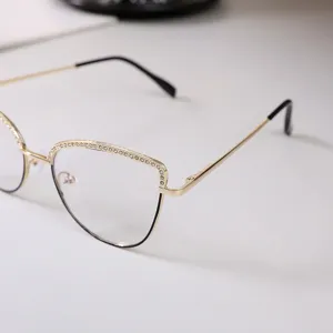 Close-up of women's gold cat eye glasses frame with elegant rhinestone detailing