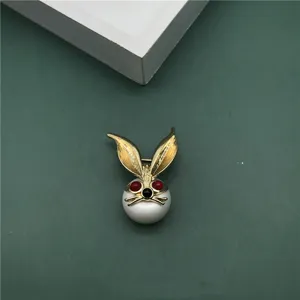 Detail of a vintage Baroque style rabbit brooch with a large white pearl base