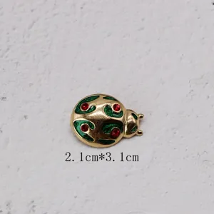 Detailed view of vintage ladybug brooch with green enamel and red rhinestones, size 2.1x3.1cm