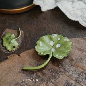 Close-up detail of vintage green enamel lily leaf brooch showing back pin and 3.7x5.4cm size