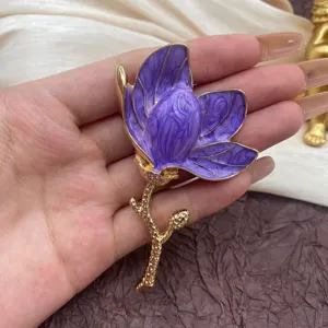 Close-up of elegant purple tulip enamel brooch with detailed gold-plated stem