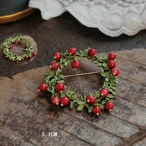 Vintage handmade enamel berry wreath brooch shown with 5.1cm diameter measurement.
