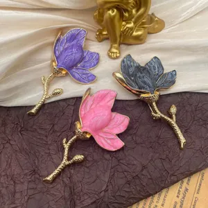 Detail of vintage enamel tulip brooches in purple, pink, and grey finishes
